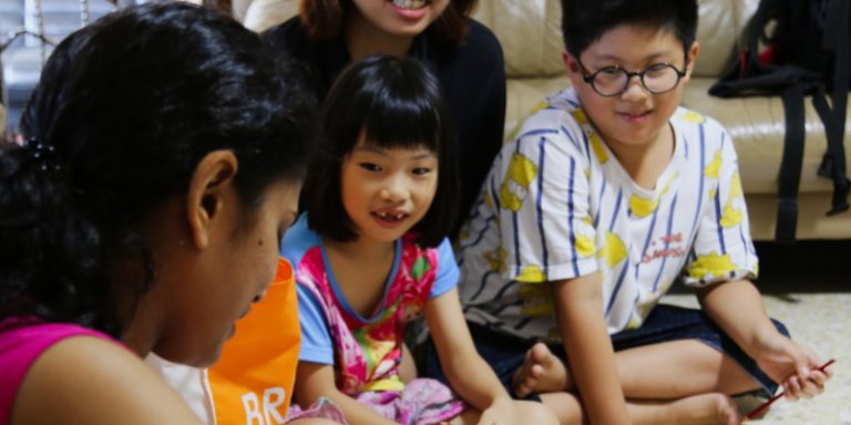 Children paying attention to a teacher in a Baha'i children's class.